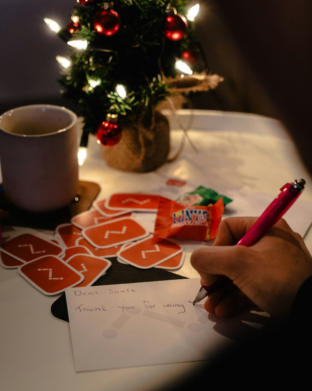 person writing on white envelope