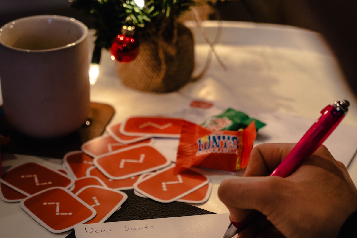 person writing on white envelope