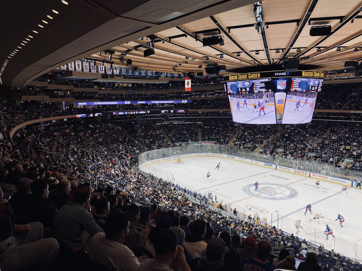 Packed hockey arena during an NHL game as fans reflect on Claude Lemieux news