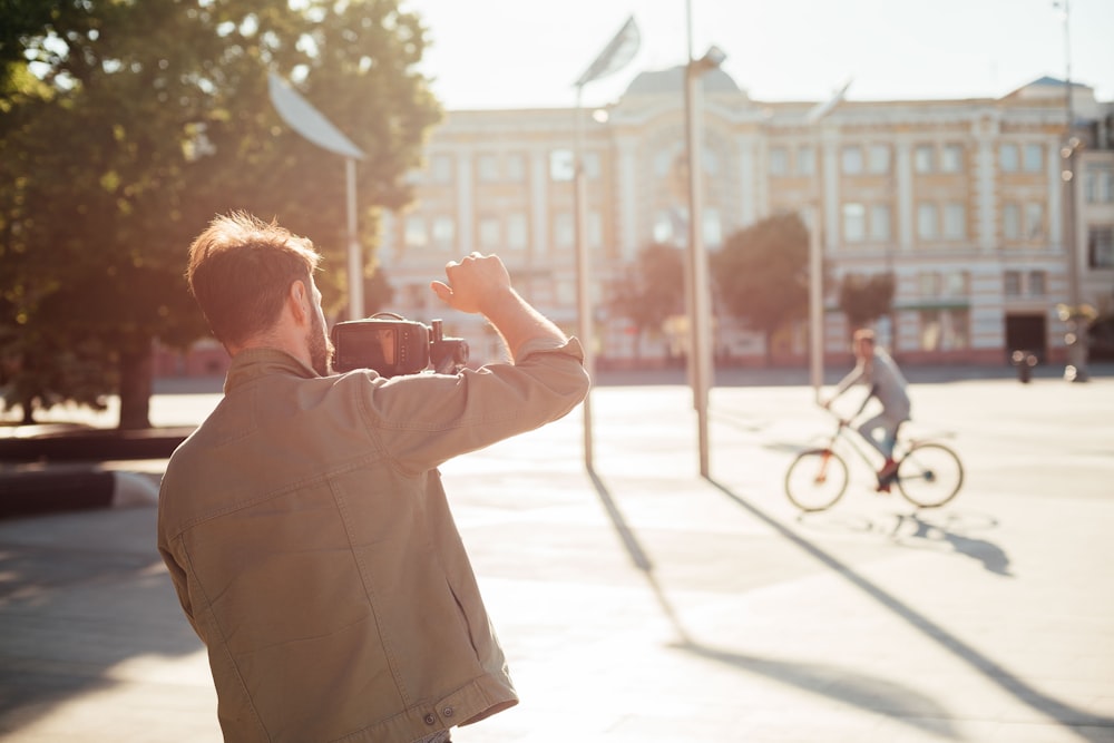 man taking photo of another man