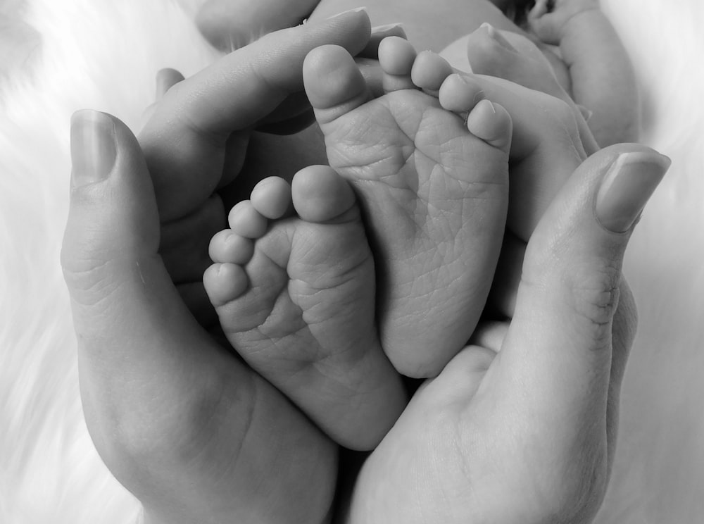 person holding baby's feet