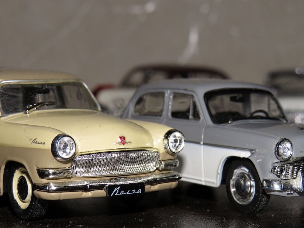 two yellow and gray die cast model toy cars
