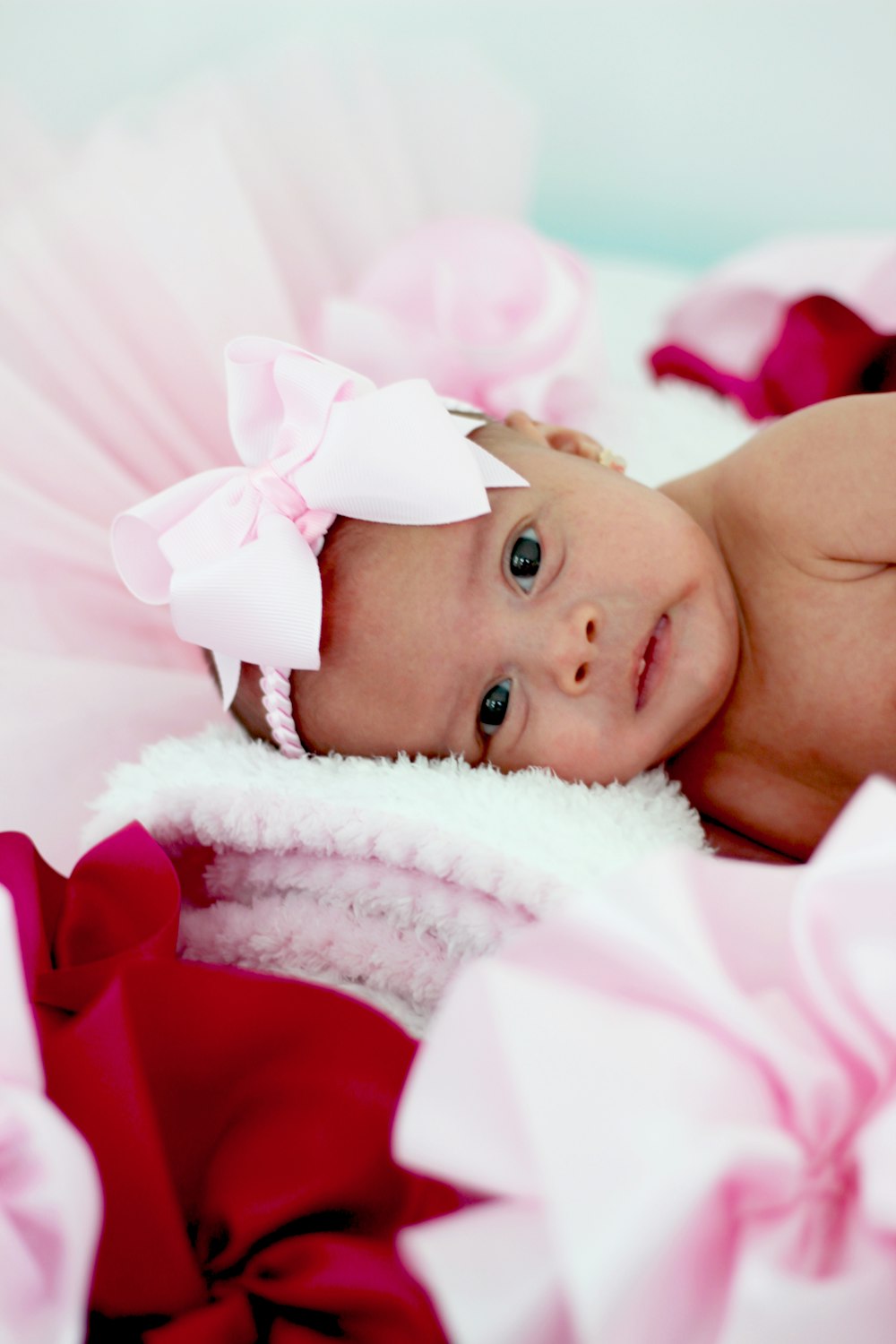 shallow focus photo of baby wearing pink headband