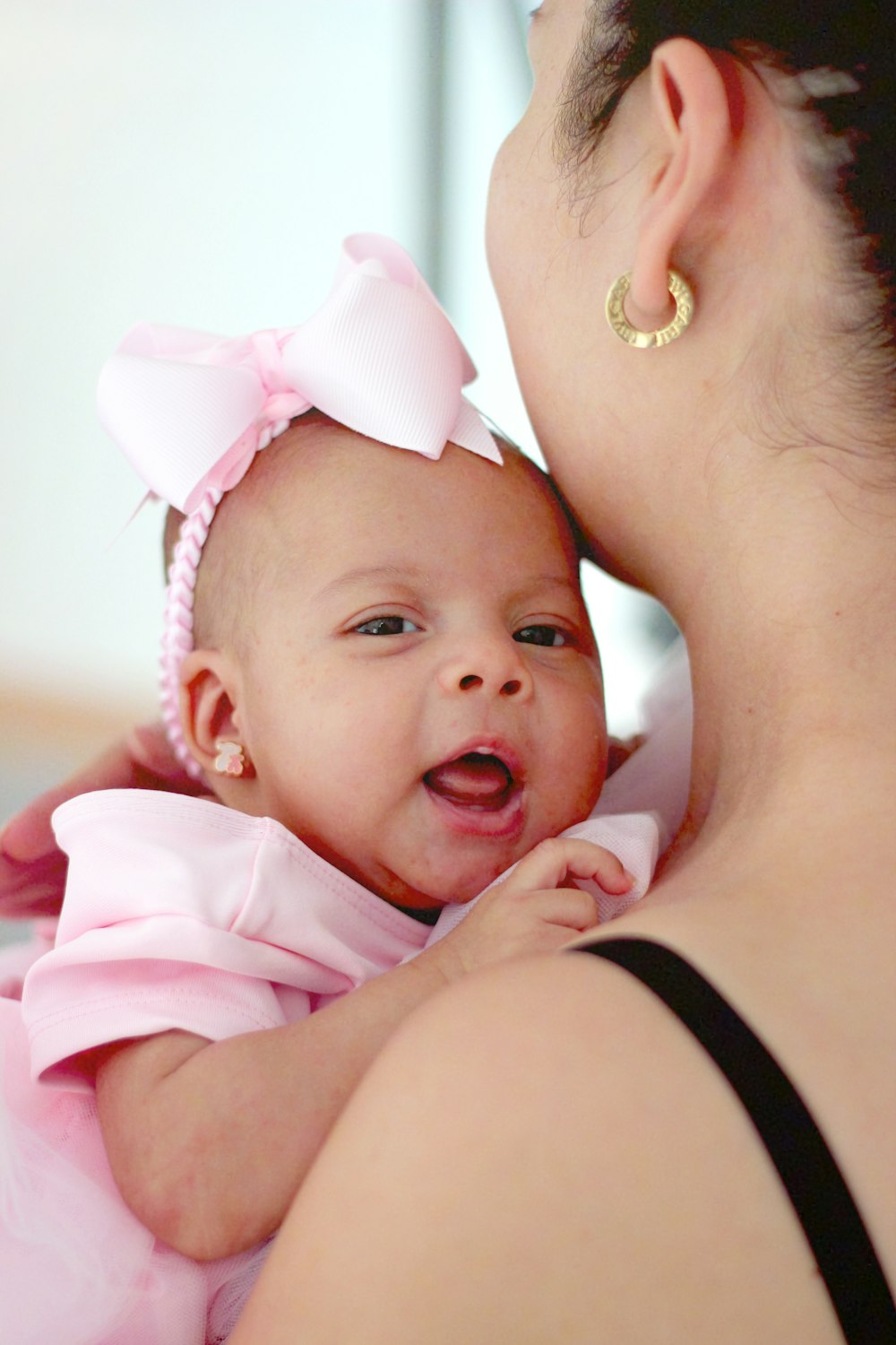 shallow focus photo of baby wearing pink headband