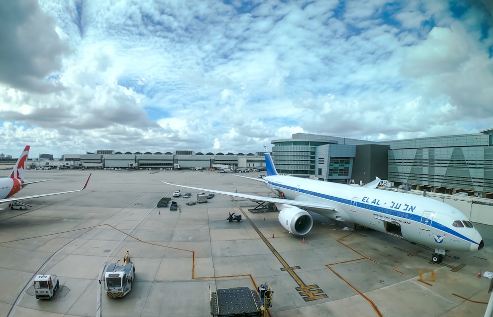 white and blue airplane during daytime