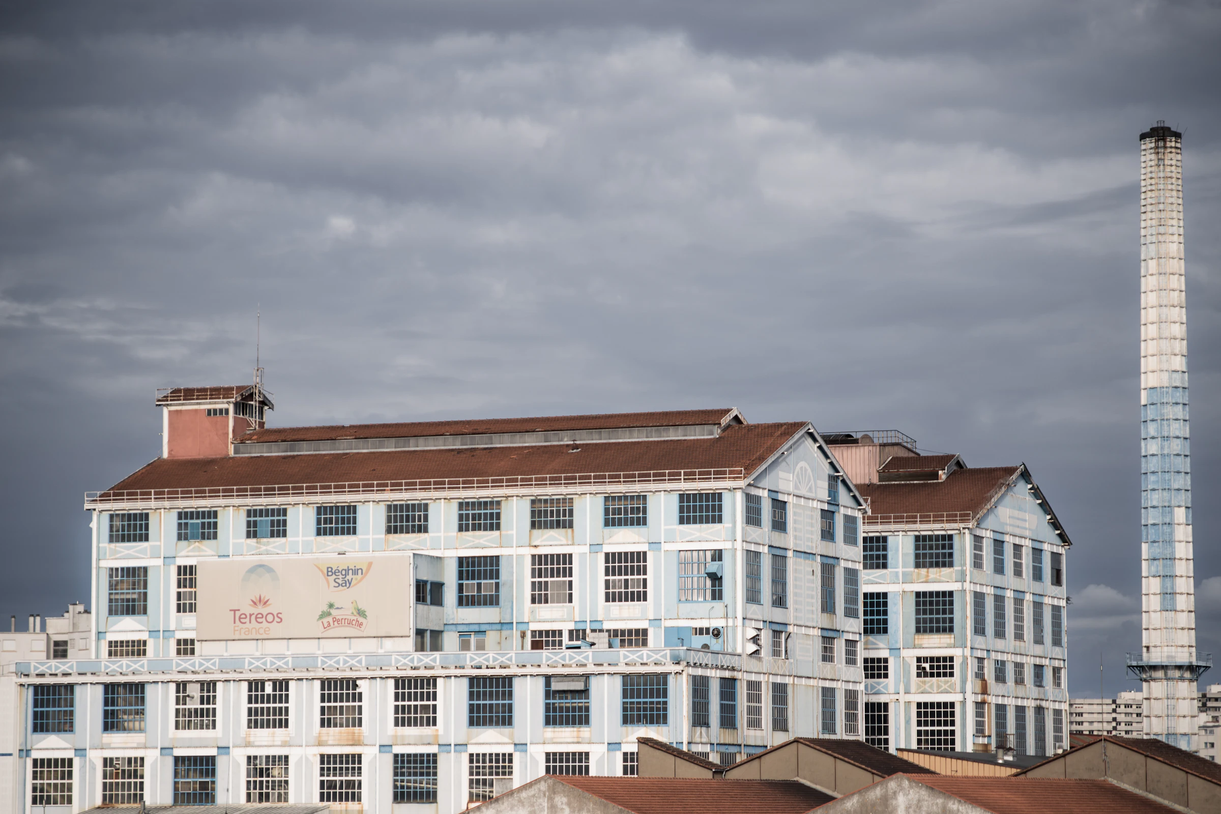 Industrial sugar refinery warehouse with bulk sugar silos and processing lines