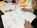 person writing on printing paper