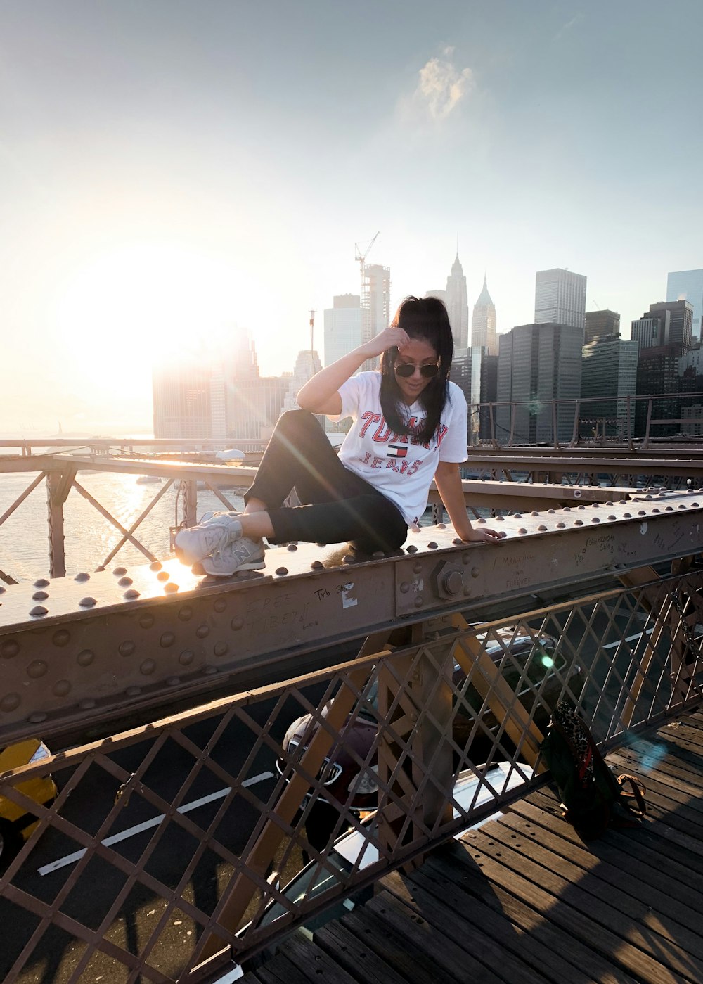 woman sitting on bridge