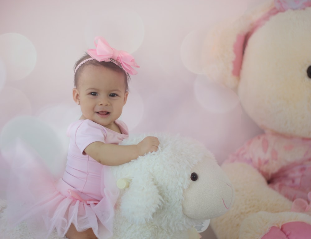shallow focus photo of baby in pink dress