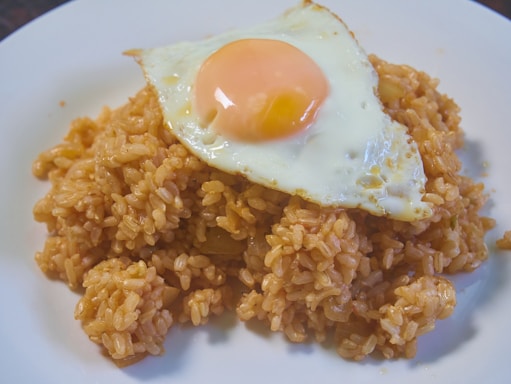 A vibrant plate of Nasi Goreng topped with fried egg.