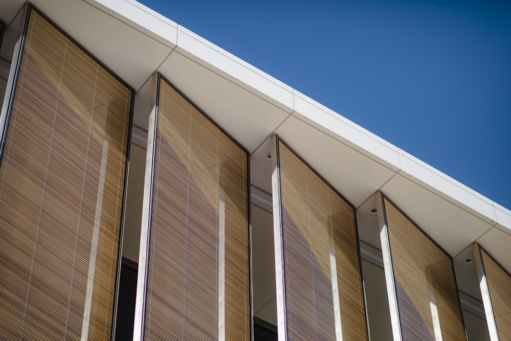 a close up of a building with wooden blinds