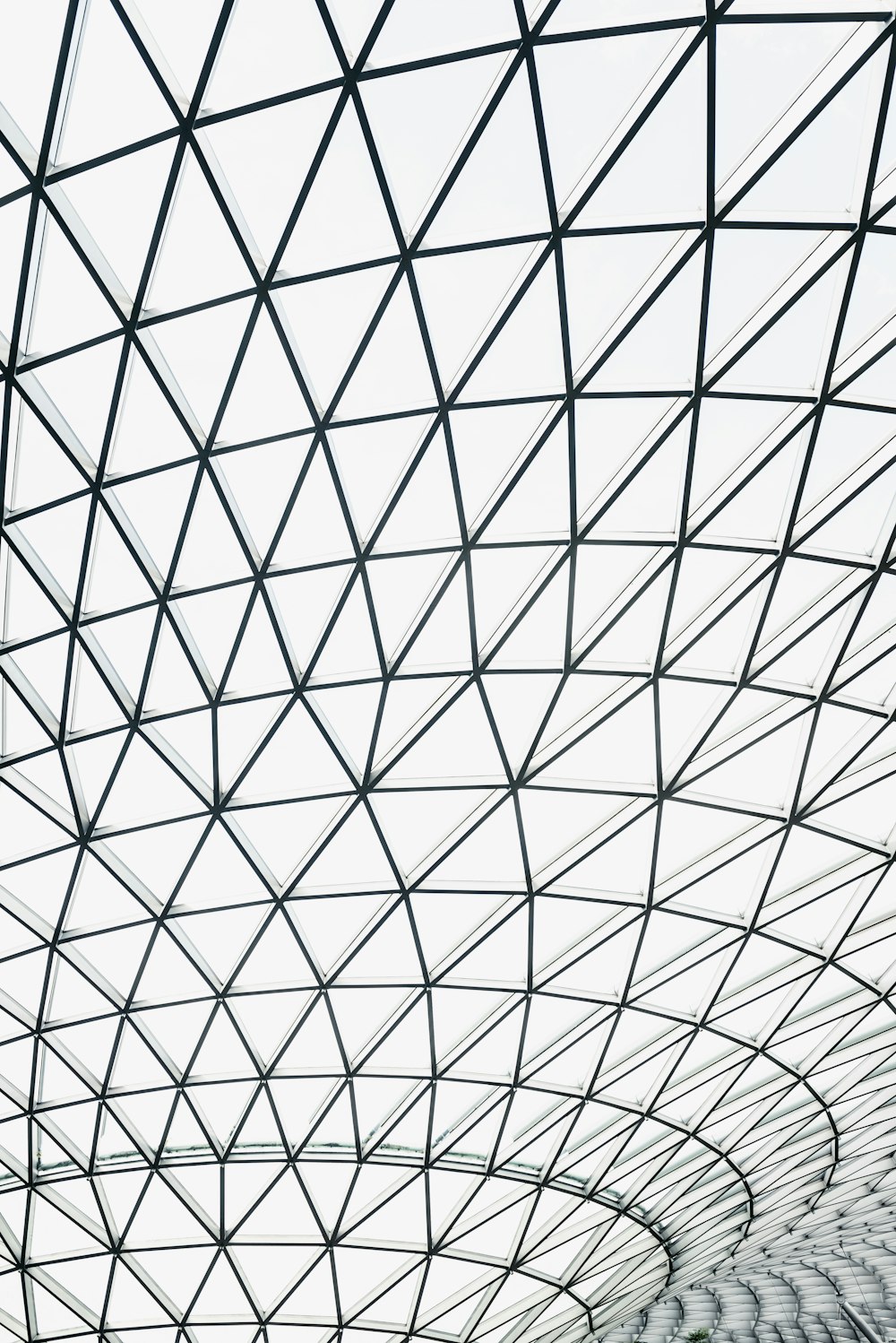 low-angle photography of glass ceiling