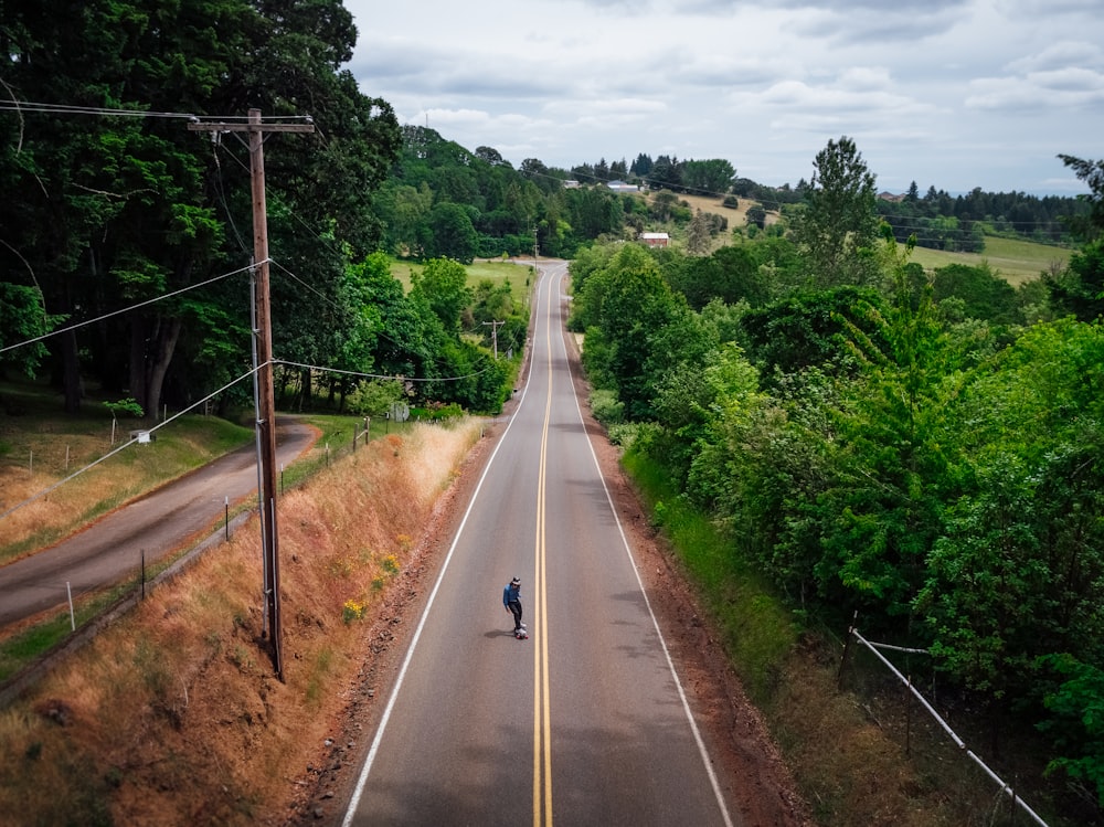 man skating on road