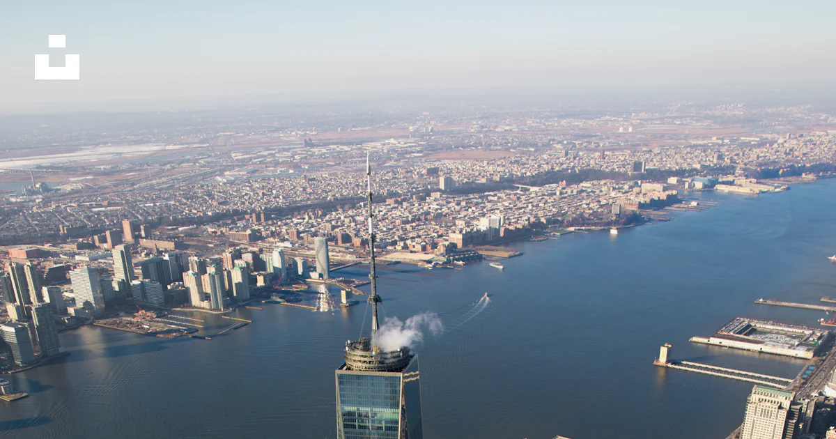 Aerial photography of city with high-rise buildings near body of water ...