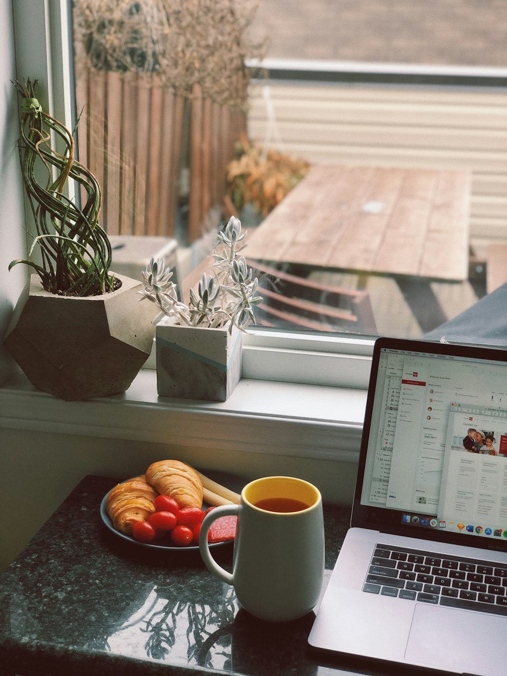 mug beside MacBook