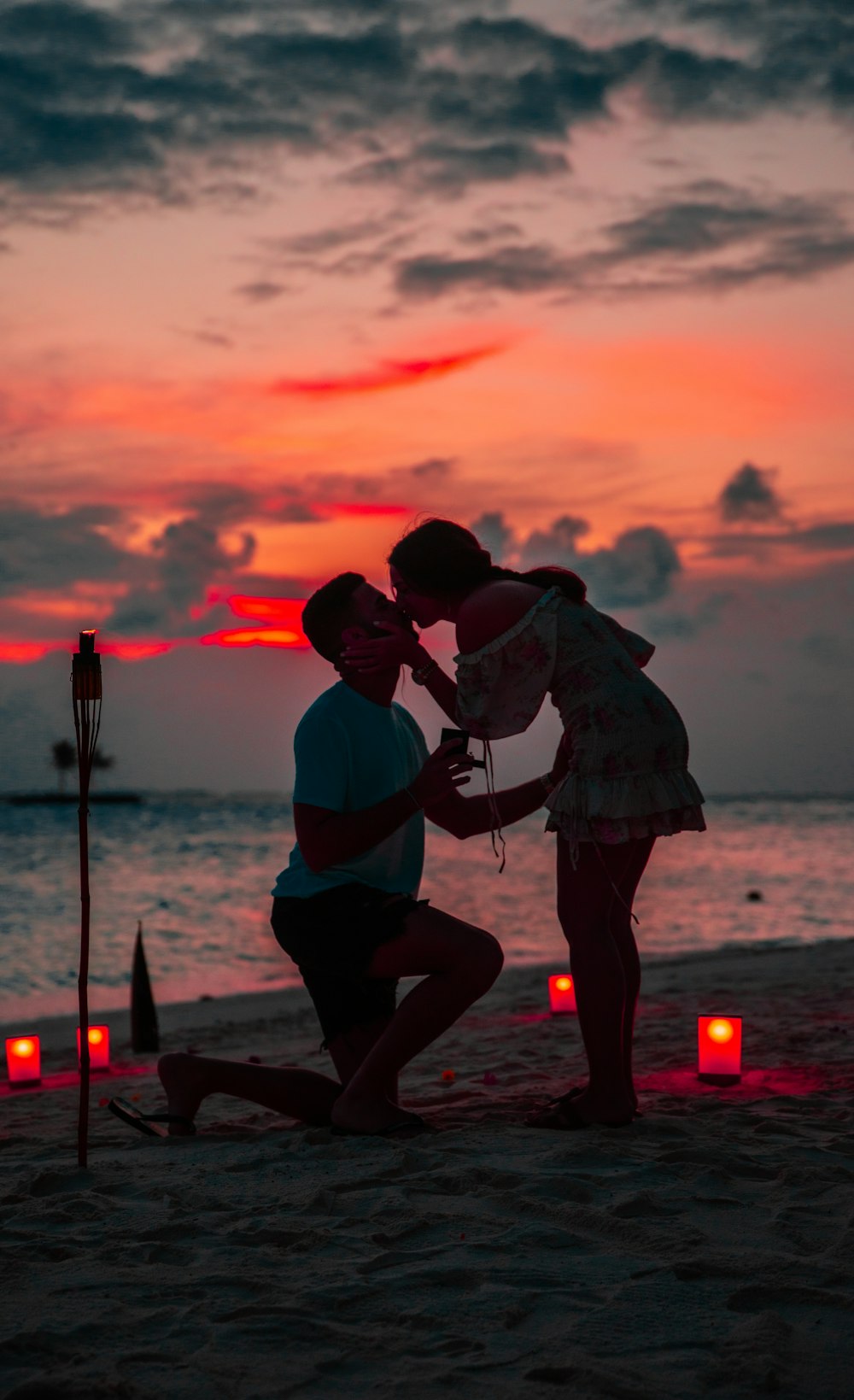 couple kissing on shore