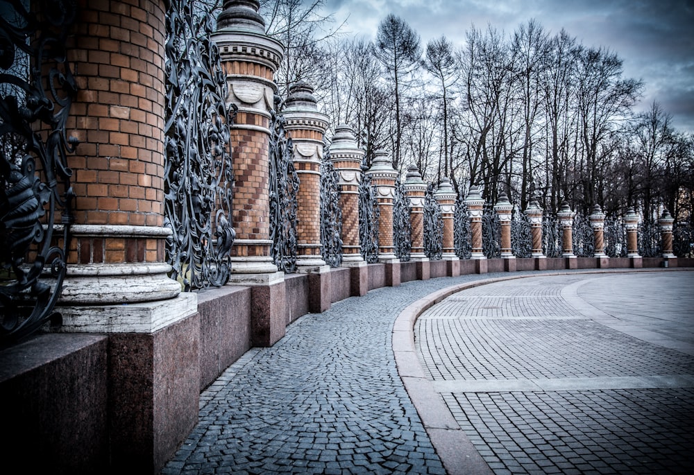 bare trees near brown pillar posts