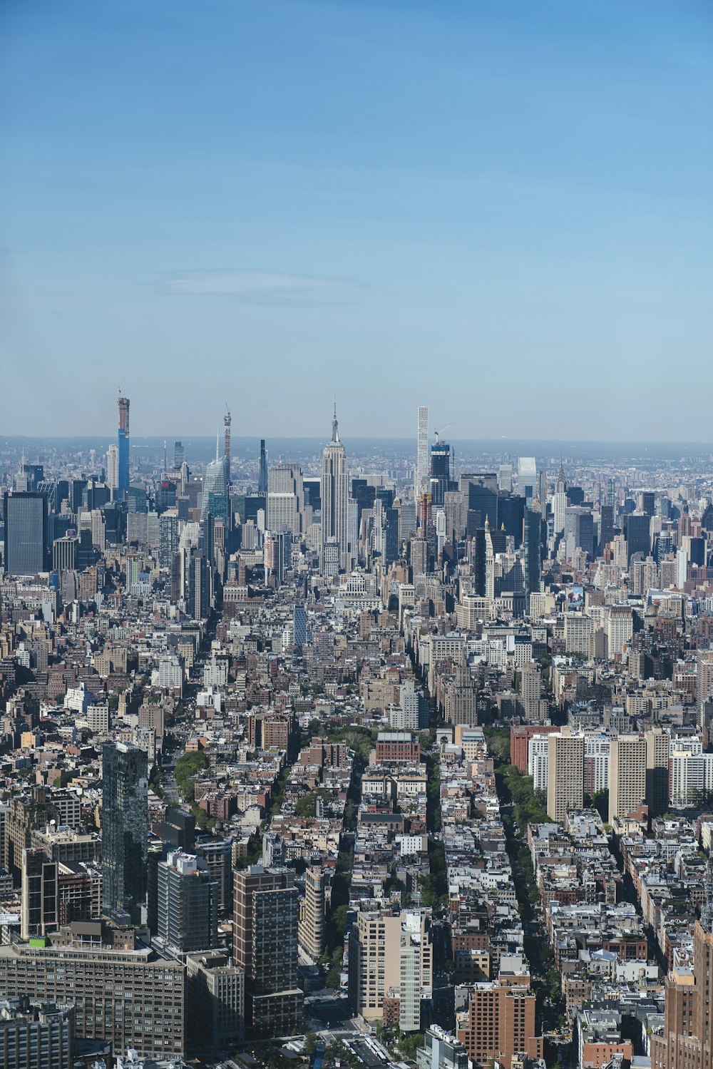 aerial photography of city with high-rise buildings under blue and white sky