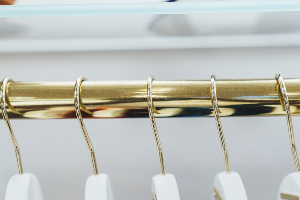 selective focus photography of gold-colored clothes hangers