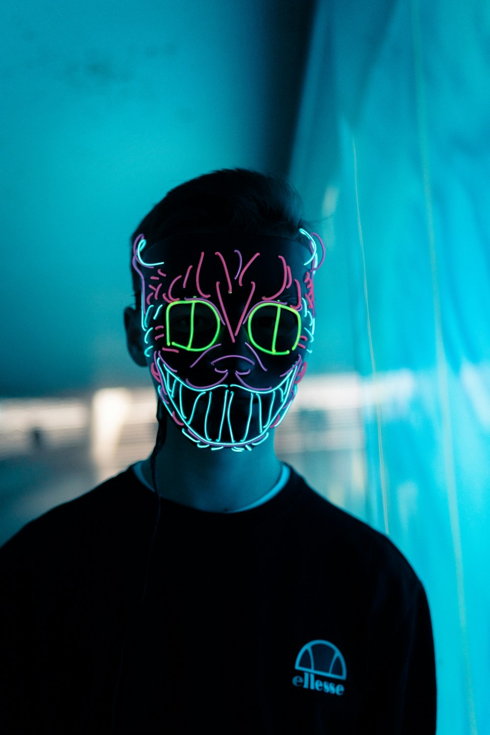 man wearing cat neon light mask