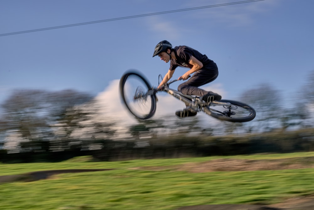 time lapse photo of man riding bike