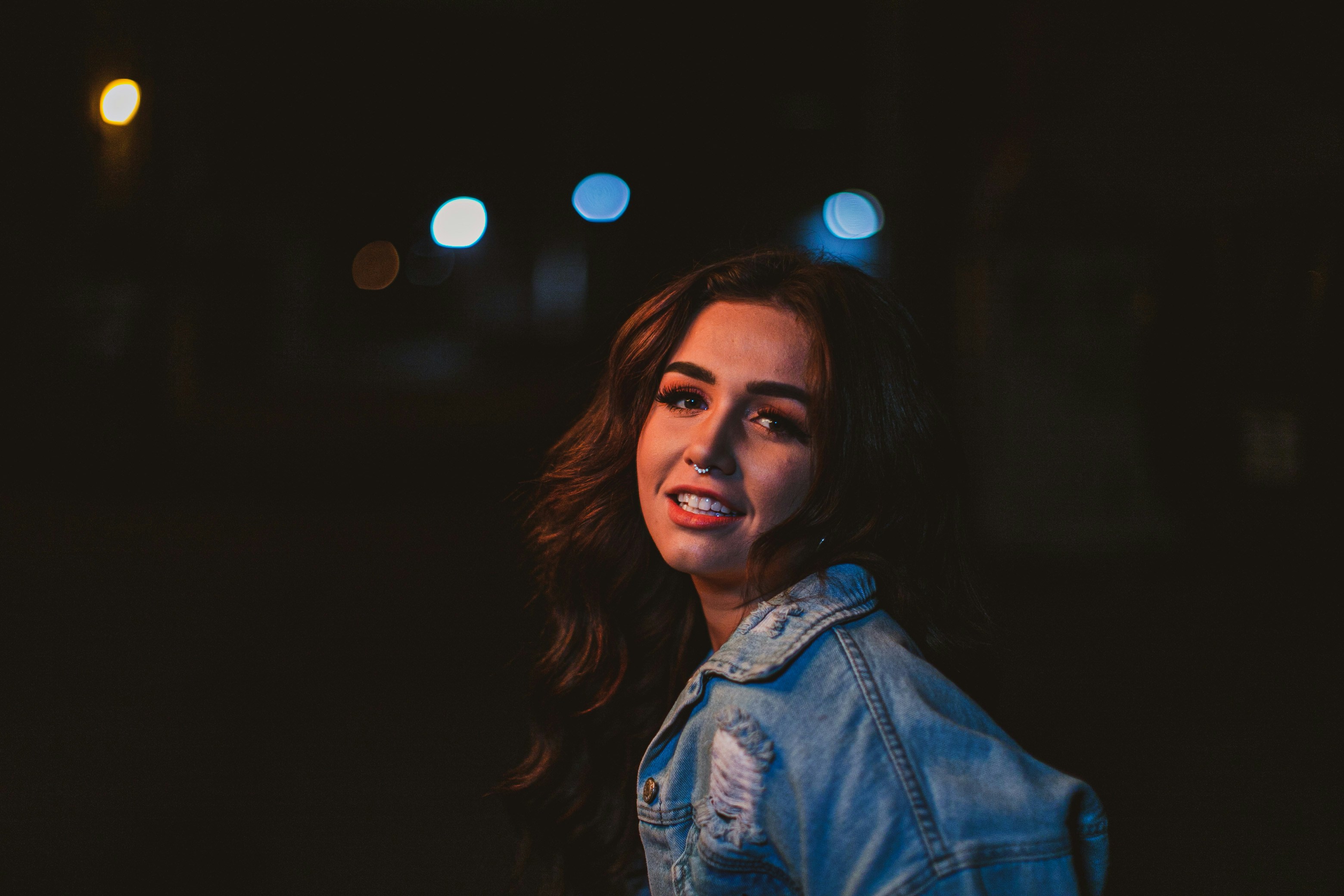 shallow focus photo of woman in blue denim jacket