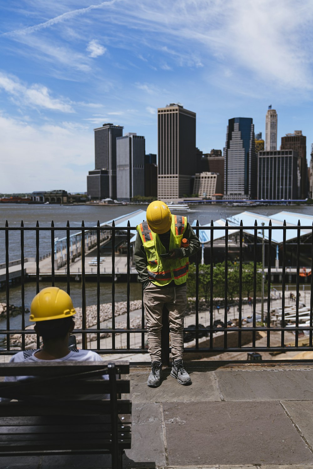 man leaning against a fence