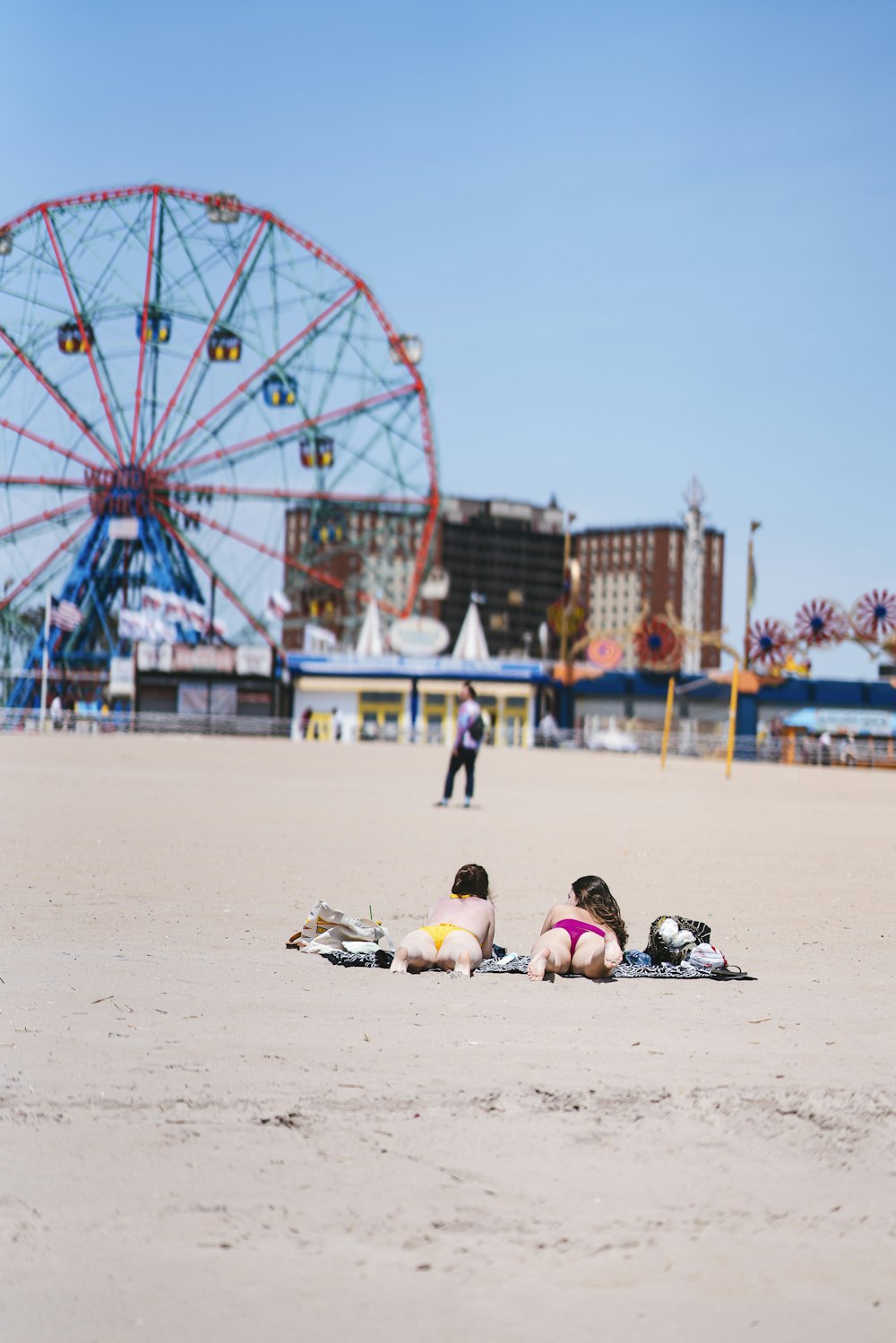 two women laying on a beach