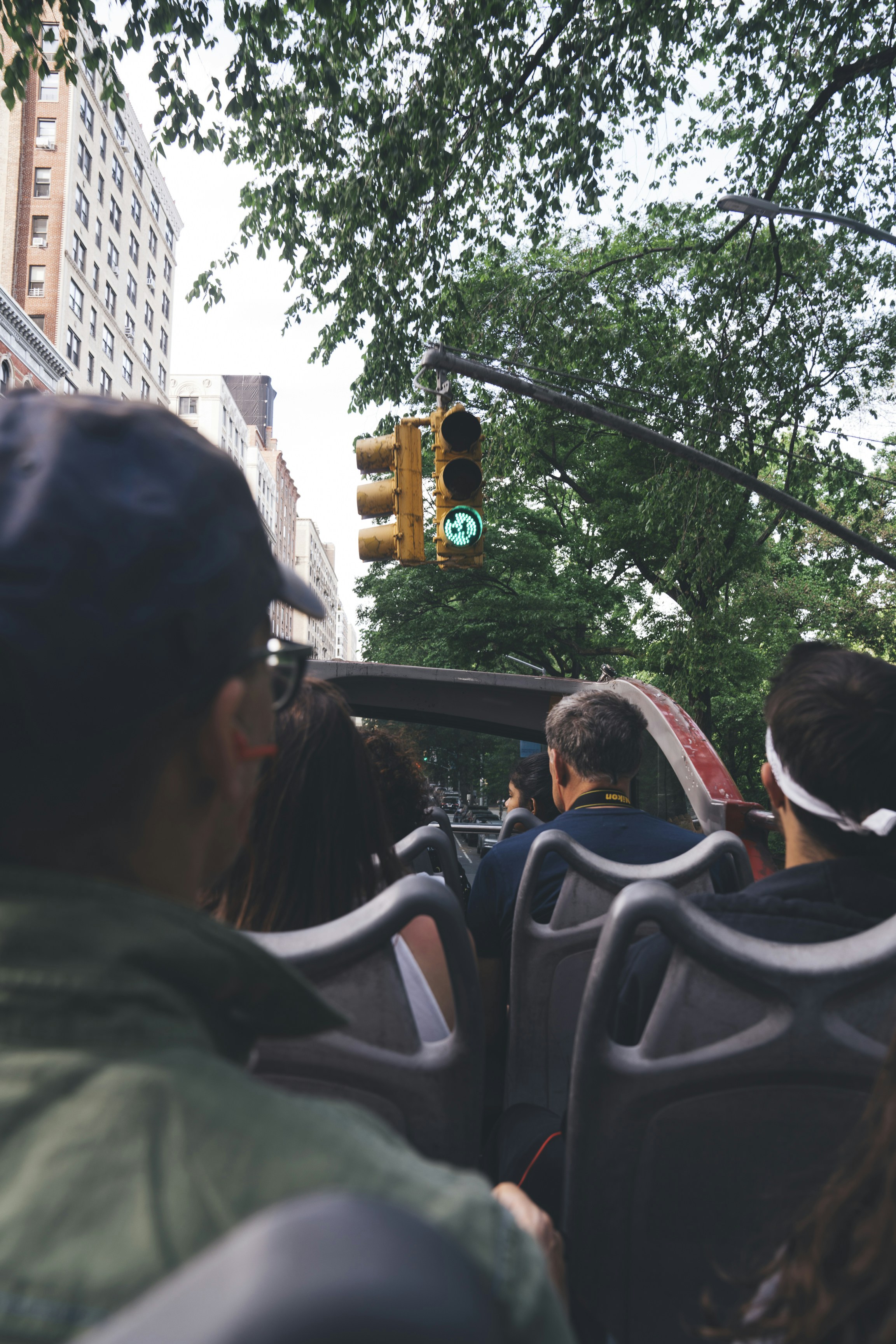 a group of people riding on the back of a bus