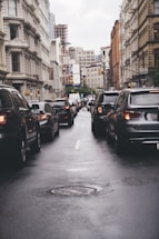 different vehicles on road viewing high-rise buildings during daytime