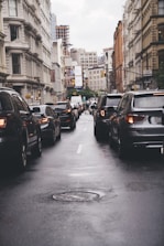 different vehicles on road viewing high-rise buildings during daytime