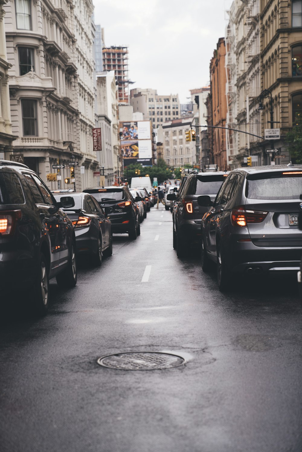 different vehicles on road viewing high-rise buildings during daytime