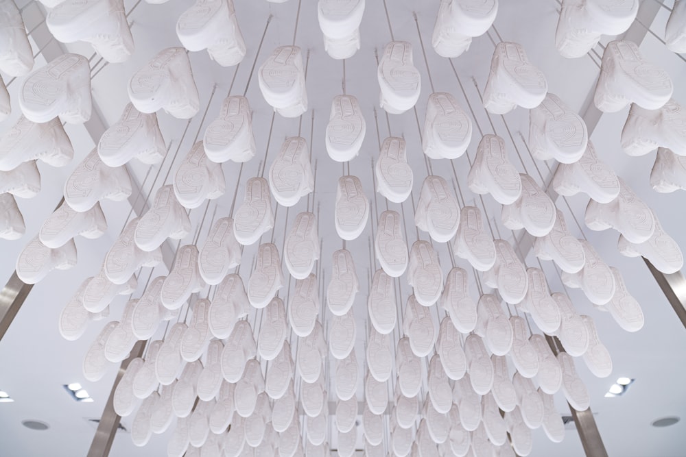 a room filled with lots of white objects hanging from the ceiling