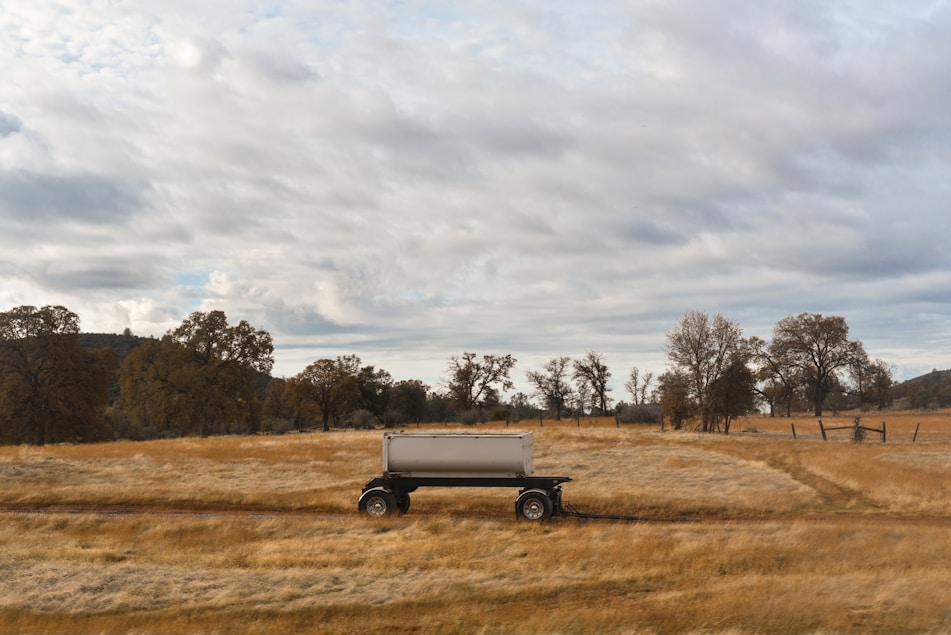 a truck is parked in the middle of a field