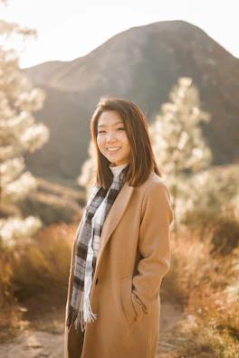 Nancy standing against a backdrop of Catalina foothills at golden hour, wrapped in a soft shawl.