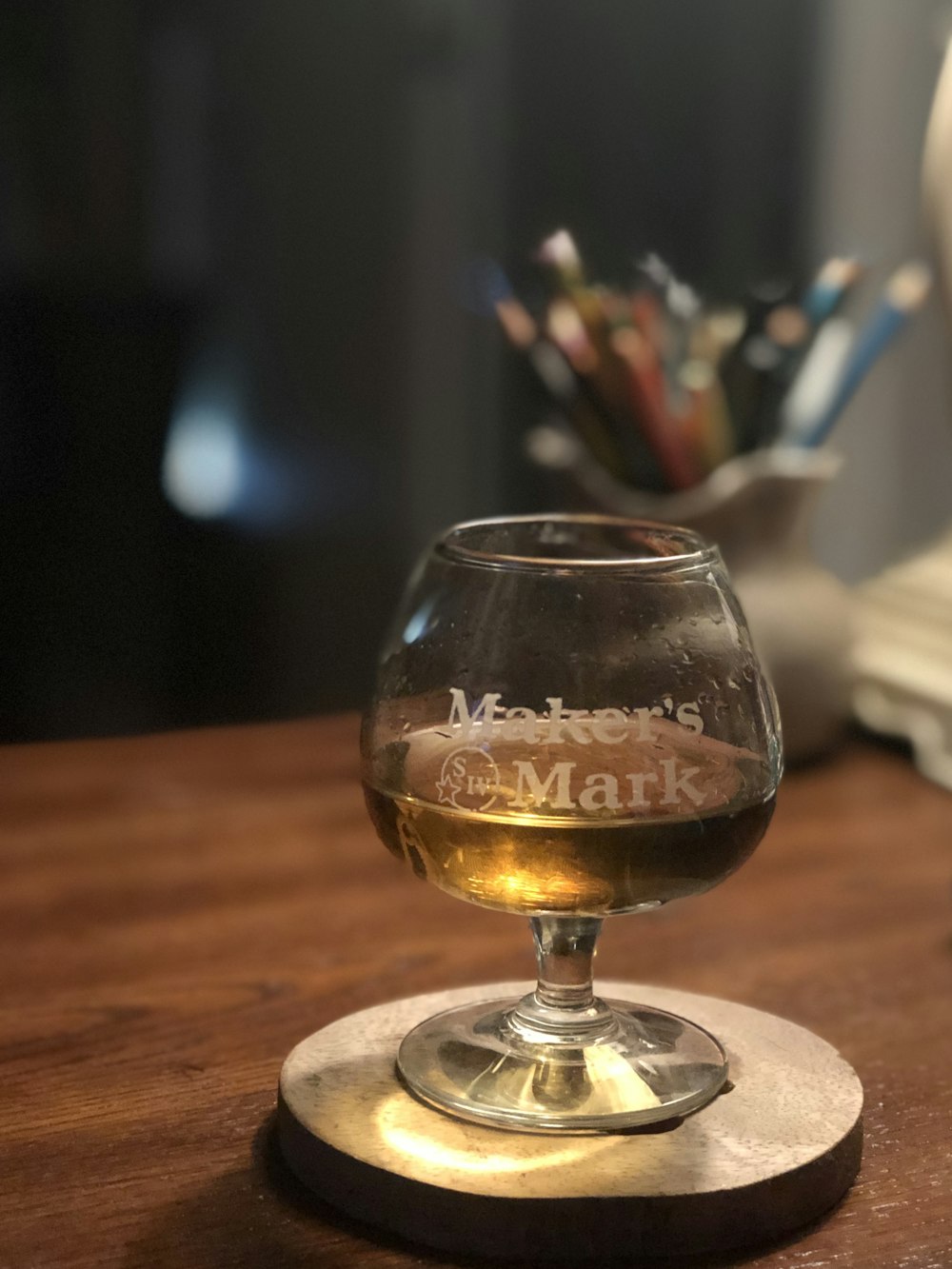 glass of white wine in Maker's Mark glass