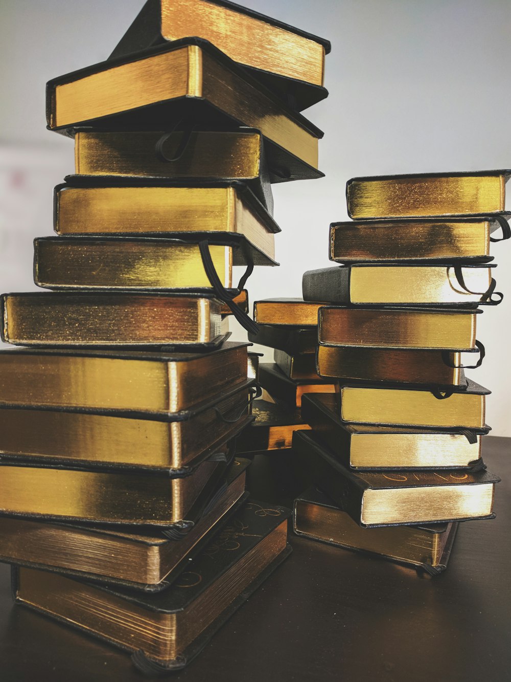 pile of black covered books