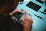 person repairing smartphones under a lighted table