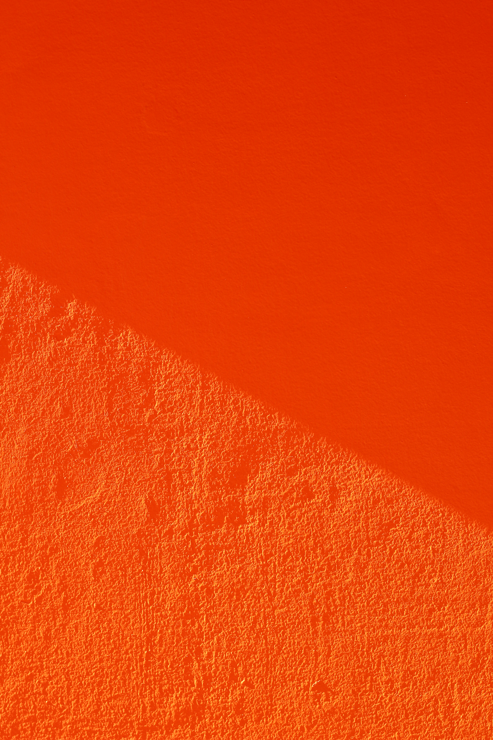 an orange wall with a shadow on it