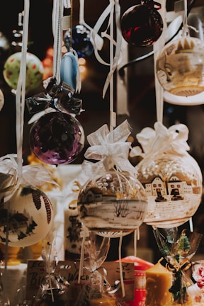 A curated set of charming ornaments arranged on a soft fabric, ready to adorn any holiday tree.