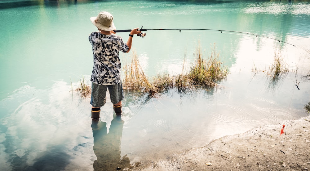 man fishing on river during daytime