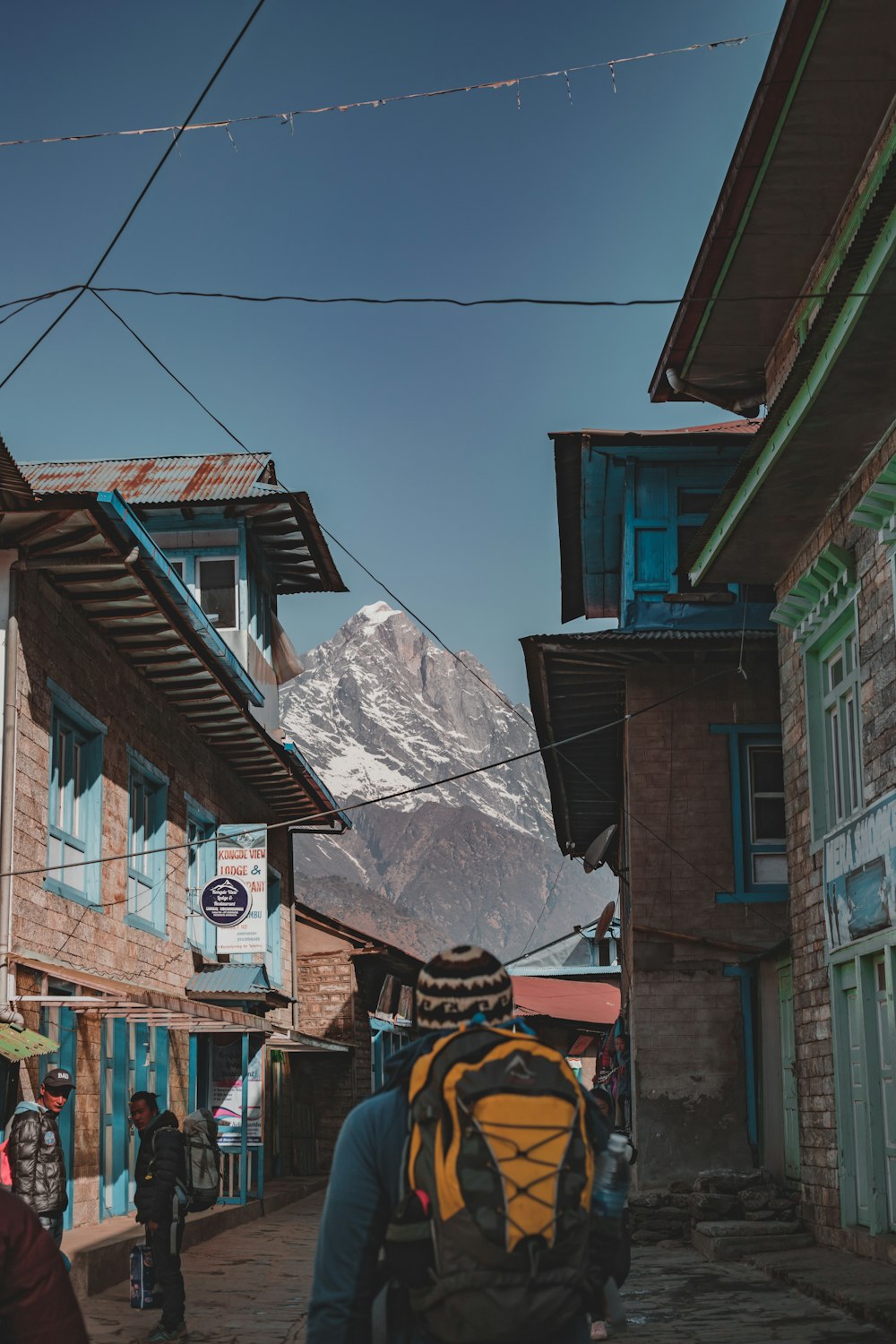 man carrying yellow and black backpack