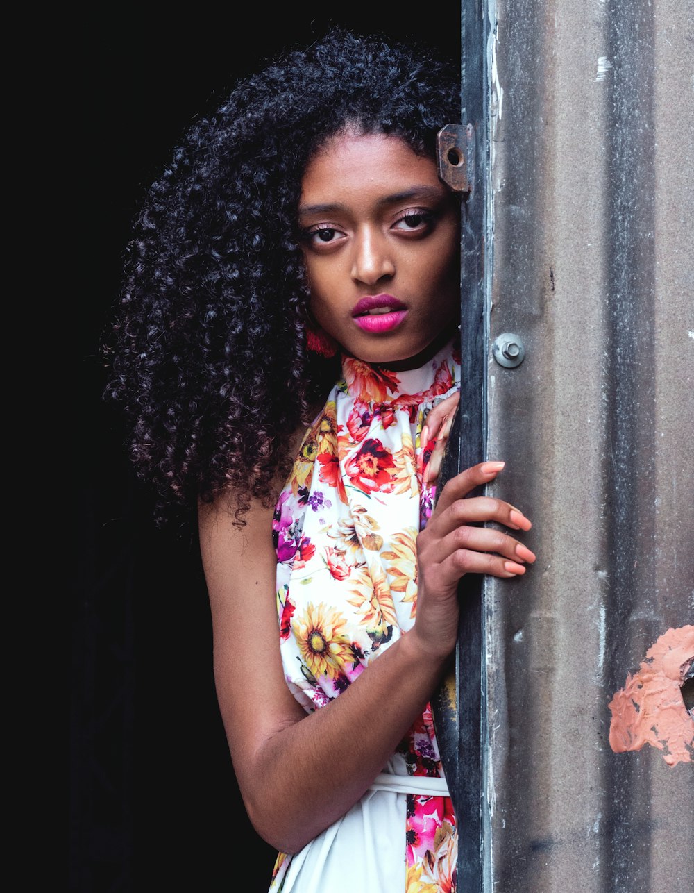 woman wearing red, white ,and orange floral dress