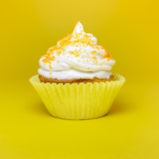 cupcake top with cream in yellow cupcake holder