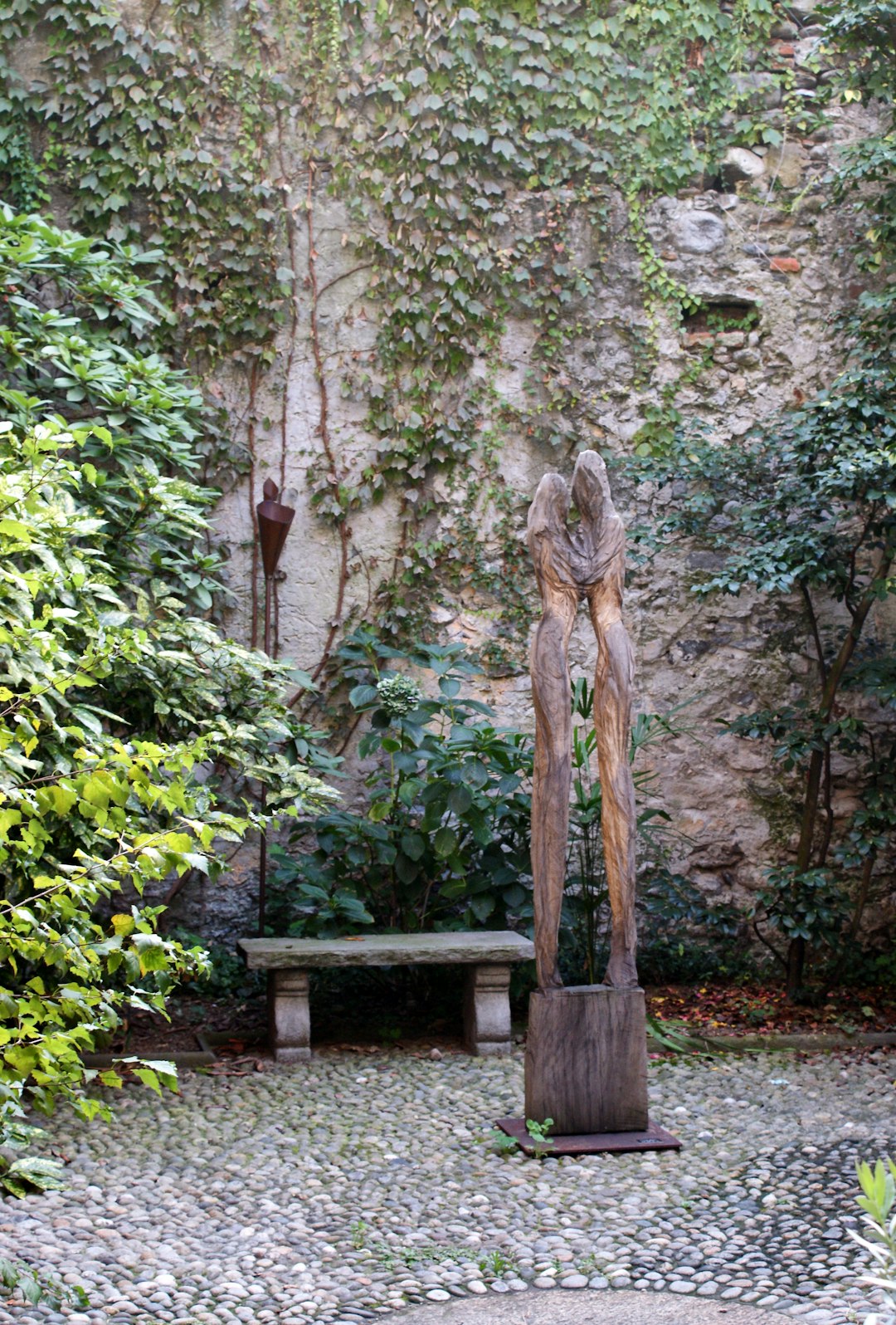 statue near bench beside garden