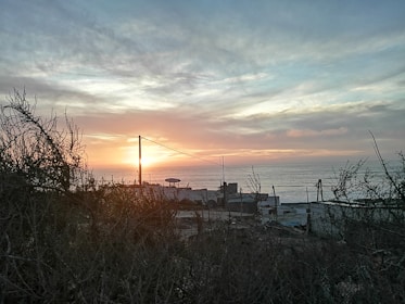 Coastal landscape with vibrant sunset over the ocean.