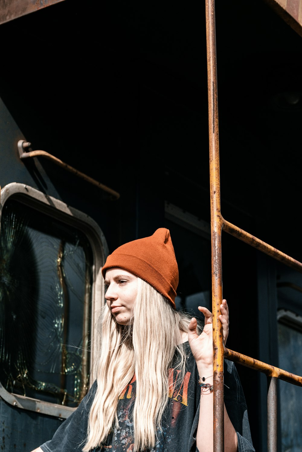 a woman with long blonde hair wearing a brown hat