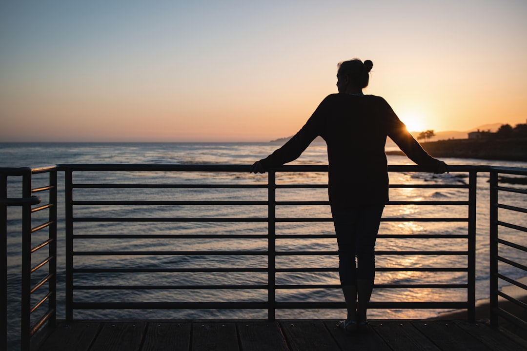 silhouette of person in front of body of water