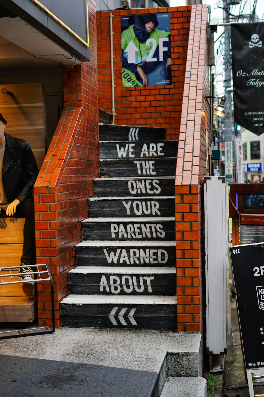 black and orange concrete stairs with we are the ones your parents warned about print