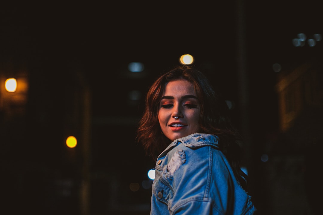 shallow focus photo of woman in blue denim jacket